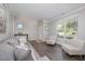Cozy living room featuring hardwood floors, neutral tones, and lots of natural light at 1211 Whispering Oak Ln, Durham, NC 27704