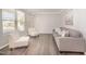 Bright living room with neutral tones, hardwood floors, and stylish furniture at 1211 Whispering Oak Ln, Durham, NC 27704