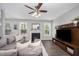 Bright living room showcases a fireplace, media center, and lots of natural light at 1211 Whispering Oak Ln, Durham, NC 27704