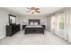 Spacious main bedroom with carpet, large dark-wood bed, dresser, and bright windows at 1211 Whispering Oak Ln, Durham, NC 27704