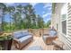 Outdoor patio with wicker furniture, a grill, and a view of the backyard at 1211 Whispering Oak Ln, Durham, NC 27704