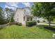 Well-maintained lawn and landscaping along side of house, showing good curb appeal and property size at 1211 Whispering Oak Ln, Durham, NC 27704
