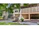 Exterior showcasing a screened-in porch, large windows, and a well-maintained backyard with stone patio at 12504 Bayleaf Church Rd, Raleigh, NC 27614
