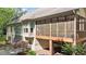 Back exterior view of a home with a screened porch and patio with multiple windows for natural light at 12504 Bayleaf Church Rd, Raleigh, NC 27614