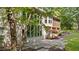 Exterior view showing a patio and the backyard landscape, including mature trees and greenery at 12504 Bayleaf Church Rd, Raleigh, NC 27614