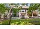 Backyard view with large windows, stone patio, well manicured lawn and a variety of mature trees and shrubbery at 12504 Bayleaf Church Rd, Raleigh, NC 27614