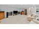 Spacious basement rec room with neutral walls, carpet floors, entertainment center, and comfortable seating at 12504 Bayleaf Church Rd, Raleigh, NC 27614