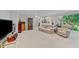 Large finished basement space with carpet, a wet bar, and stairwell access to an outdoor green space at 12504 Bayleaf Church Rd, Raleigh, NC 27614