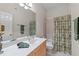 Bathroom featuring a vanity with a white countertop, framed mirror, and shower with decorative curtain at 12504 Bayleaf Church Rd, Raleigh, NC 27614