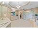 Bright bathroom featuring a walk-in shower, vanity with dual sinks, and elegant lighting at 12504 Bayleaf Church Rd, Raleigh, NC 27614