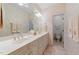 Elegant bathroom with a double sink vanity, large mirror, and wallpaper with a seashell design at 12504 Bayleaf Church Rd, Raleigh, NC 27614