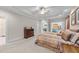 Bright bedroom boasting a tray ceiling, a ceiling fan, neutral walls and plush carpet at 12504 Bayleaf Church Rd, Raleigh, NC 27614