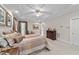Spacious bedroom featuring a tray ceiling with ceiling fan, neutral walls, and plush carpet at 12504 Bayleaf Church Rd, Raleigh, NC 27614