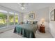 Cozy bedroom with large windows, a ceiling fan, neutral walls, and plush carpet at 12504 Bayleaf Church Rd, Raleigh, NC 27614
