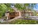 Back exterior of a two-story brick home featuring an attached two car garage and screened-in porch at 12504 Bayleaf Church Rd, Raleigh, NC 27614