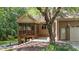 Back exterior featuring a screened-in porch and brick siding, creating a welcoming outdoor space at 12504 Bayleaf Church Rd, Raleigh, NC 27614