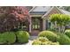 Inviting front entrance framed by lush landscaping, pillars, and brickwork for a grand arrival at 12504 Bayleaf Church Rd, Raleigh, NC 27614