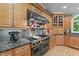 Gourmet kitchen with stainless steel appliances, custom cabinets, granite countertops and a professional range at 12504 Bayleaf Church Rd, Raleigh, NC 27614