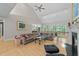Spacious living room with high ceilings, fireplace, large windows, and comfortable seating with nature views at 12504 Bayleaf Church Rd, Raleigh, NC 27614