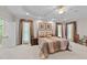 Large main bedroom featuring a tray ceiling, carpeted floors, and ensuite bathroom at 12504 Bayleaf Church Rd, Raleigh, NC 27614