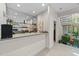 Entertainer's wet bar featuring mirrored backsplash, countertop, sink, and access to the lower level at 12504 Bayleaf Church Rd, Raleigh, NC 27614