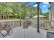 Relaxing back deck with metal pergola overlooking green trees and landscaped backyard at 1309 Caribou Xing, Durham, NC 27713