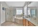 Elegant bathroom with glass-enclosed shower, soaking tub, and vanity offering a spa-like experience at 1309 Caribou Xing, Durham, NC 27713