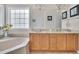 Bright bathroom featuring a soaking tub, double vanity, and ample natural light for a refreshing start at 1309 Caribou Xing, Durham, NC 27713