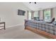 Comfortable bedroom with high ceilings, modern media, and a dedicated workspace for convenience at 1309 Caribou Xing, Durham, NC 27713
