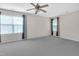 Neutral bedroom with a ceiling fan, carpet flooring, and two windows providing ample natural light at 1309 Caribou Xing, Durham, NC 27713