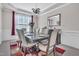 Bright dining room with a modern chandelier, neutral paint, and an elegant dining set for Gathering gatherings at 1309 Caribou Xing, Durham, NC 27713