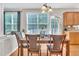 Dining room features a wooden table, four chairs, a window with blinds and an exterior glass door at 1309 Caribou Xing, Durham, NC 27713