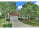 Desirable brick home with an attached two-car garage, mature landscaping, and a long driveway at 1309 Caribou Xing, Durham, NC 27713