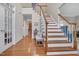 Grand foyer featuring hardwood floors, a staircase, and light neutral paint, creating a welcoming atmosphere at 1309 Caribou Xing, Durham, NC 27713