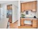 Kitchen area with stainless steel refrigerator and breakfast nook including wooden cabinets and built-in desk at 1309 Caribou Xing, Durham, NC 27713
