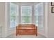 Charming window seat nestled within a sunlit bay window, offering serene views of the outdoors at 1309 Caribou Xing, Durham, NC 27713