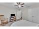 Bedroom features a large window, closet, rocking chair and TV at 1311 Theodore Ln, Durham, NC 27703