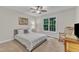 Bright bedroom with a large window and a comfortable bed with gray pillows at 1311 Theodore Ln, Durham, NC 27703