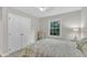 Comfortable bedroom featuring a window with natural light and a double door closet at 1311 Theodore Ln, Durham, NC 27703