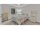Well-lit bedroom with floral bedding, a whimsical dresser, and a window view of nature at 1311 Theodore Ln, Durham, NC 27703
