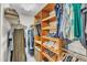 Walk-in closet with shelving, rods, and compartments for organizing clothing, shoes, and accessories at 1311 Theodore Ln, Durham, NC 27703