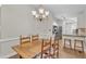 Open-concept dining space with a view to the kitchen and natural light at 1311 Theodore Ln, Durham, NC 27703