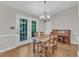 Dining room with natural light, views of backyard, chandelier and view to piano at 1311 Theodore Ln, Durham, NC 27703