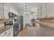 Well-lit kitchen featuring stainless steel appliances, ample white cabinetry and sleek countertops at 1311 Theodore Ln, Durham, NC 27703