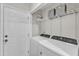 Functional laundry area with storage shelves, washer, dryer and access door at 1311 Theodore Ln, Durham, NC 27703