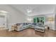 Bright living room with vaulted ceilings, hardwood floors, a plush sectional sofa, and plenty of natural light at 1311 Theodore Ln, Durham, NC 27703