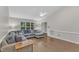 Open living room with vaulted ceilings, hardwood floors, a plush sectional sofa, and plenty of natural light at 1311 Theodore Ln, Durham, NC 27703