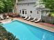 Aerial view of the pool and deck in this tree lined backyard at 14 Gloucester Ct, Durham, NC 27713