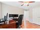 Hardwood floors in a bedroom with ceiling fan, desk and chair at 14 Gloucester Ct, Durham, NC 27713