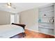 Bright bedroom offering built-in shelves and a relaxing atmosphere with natural light and serene decor at 14 Gloucester Ct, Durham, NC 27713